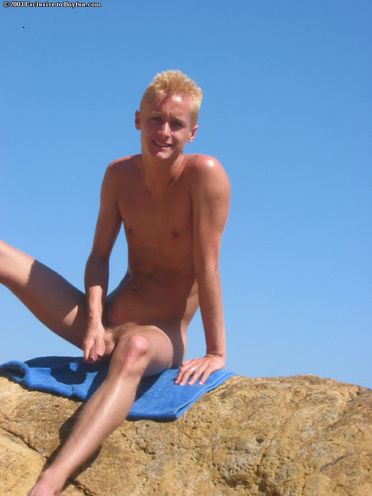 Skinny gay blonde Kyle strips his Speedos and masturbates on the beach  