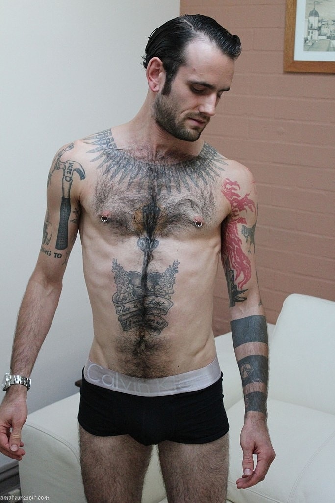Gay tattooed Rocco Hard gets naked & strokes his pierced dick until he cums  